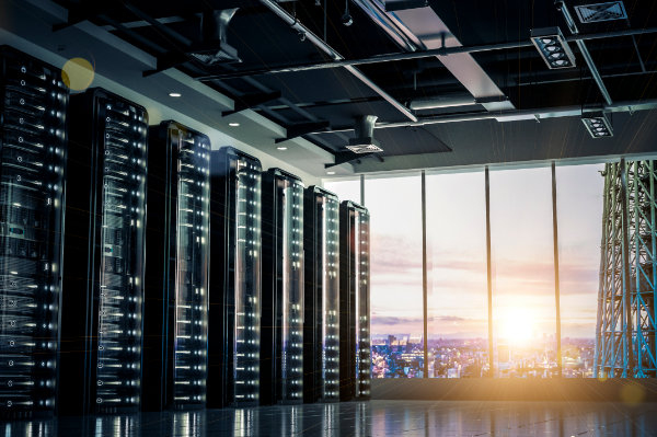 A room filled with servers on the left and a window on the right with the sun shining in.